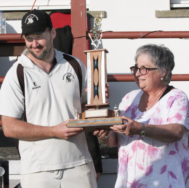 Patrick Bellerby receives the man of the match trophy from Joyce Thomas